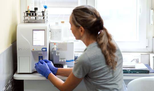 Veterinary tech works with lab equipment