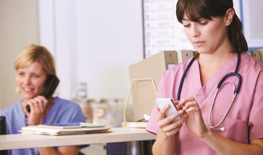 Nurses using phones to communicate with clients