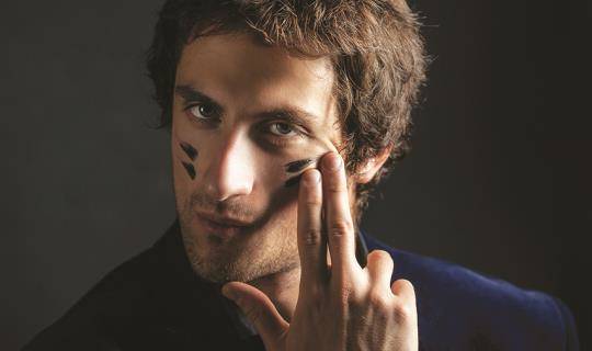 Man applying war paint to his face