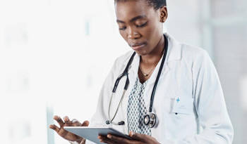 Female veterinarian using tablet