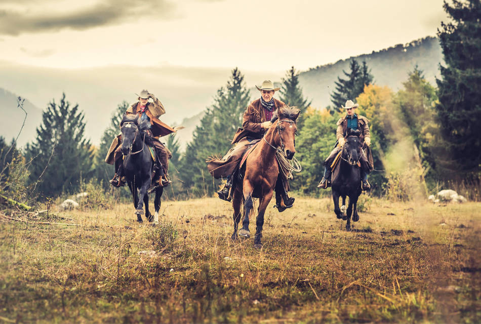 three ranchers riding horses