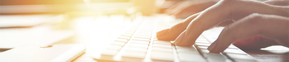 fingers typing on keyboard