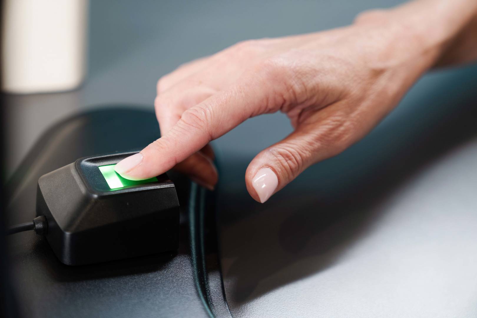 hand using biometric fingerprint scanner to access repleni trac vault