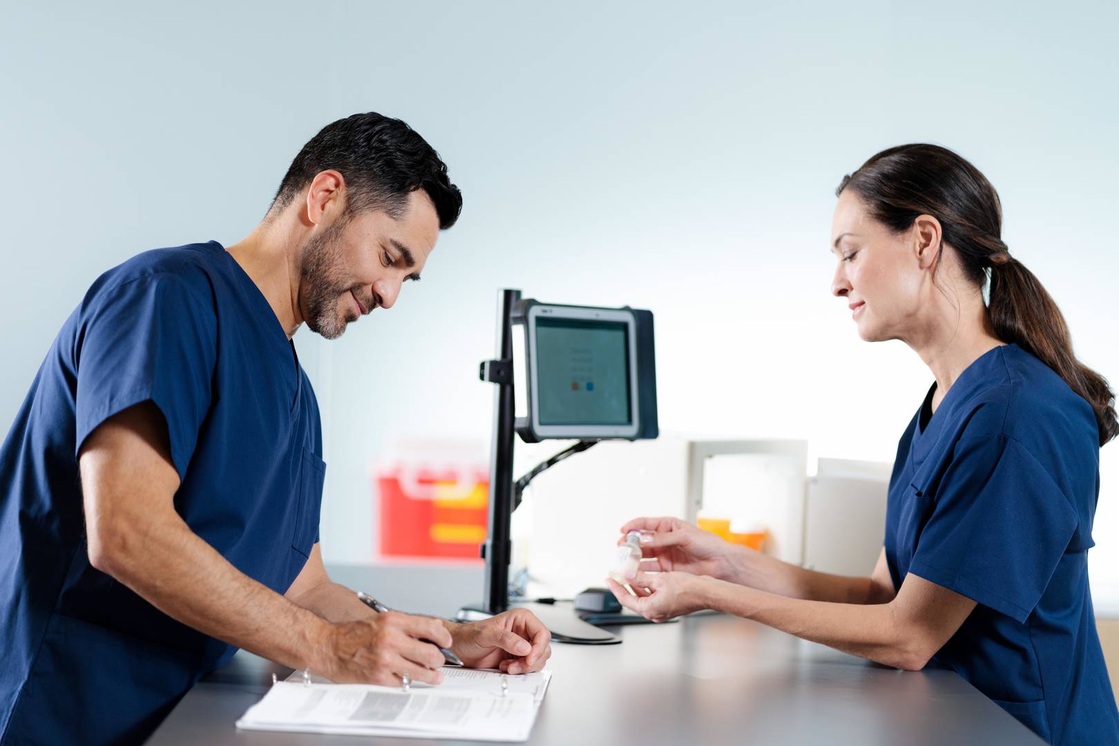 Man and women taking inventory using the repleni-trac vault