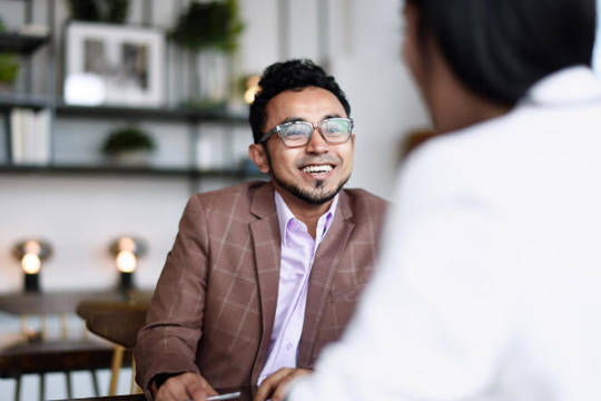 Man talking to veterinarian during a business meeting