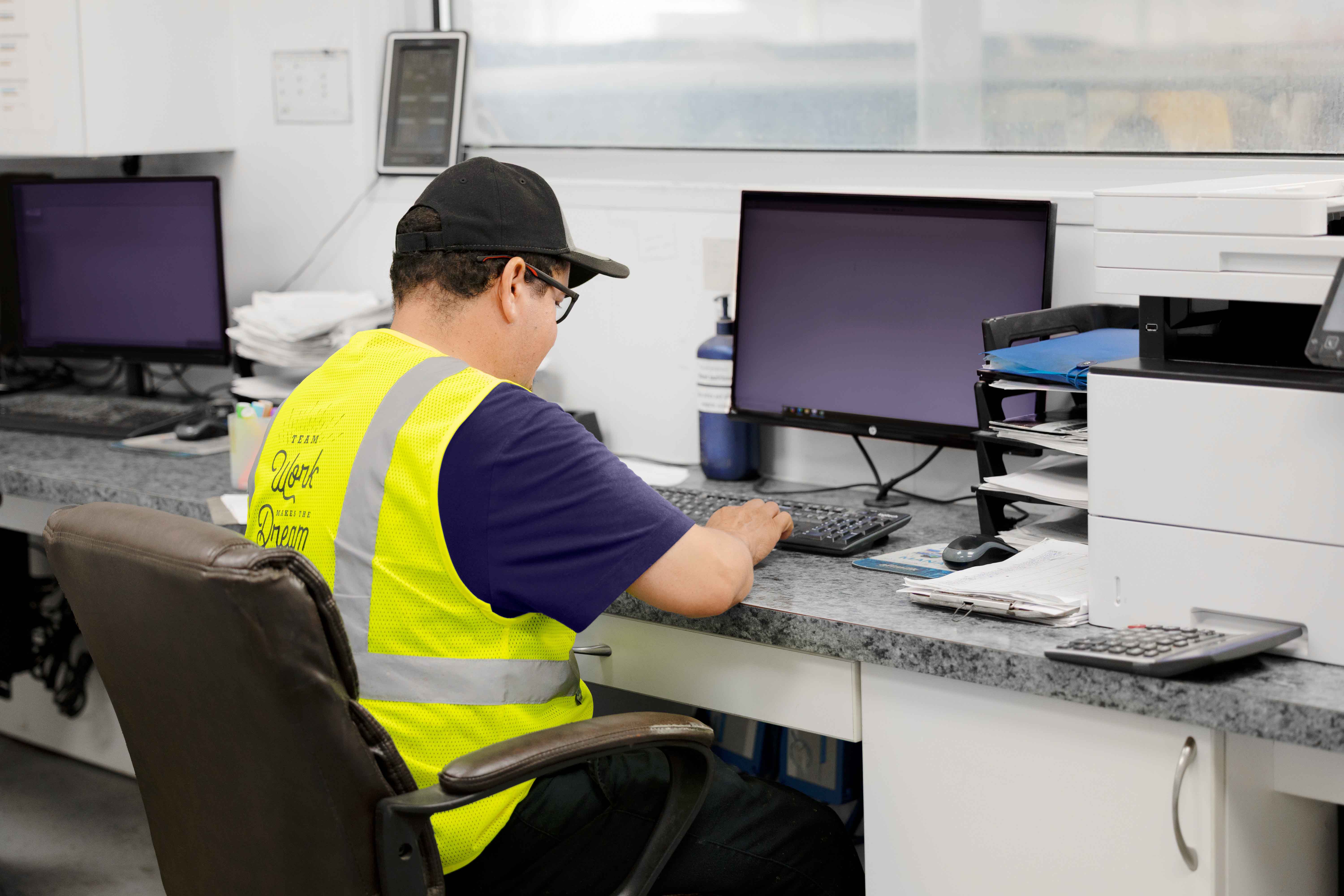 Dairy worker sitting at computer